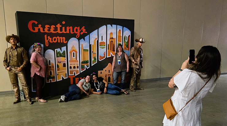 Posing with living statues at the Client Appreciation Event