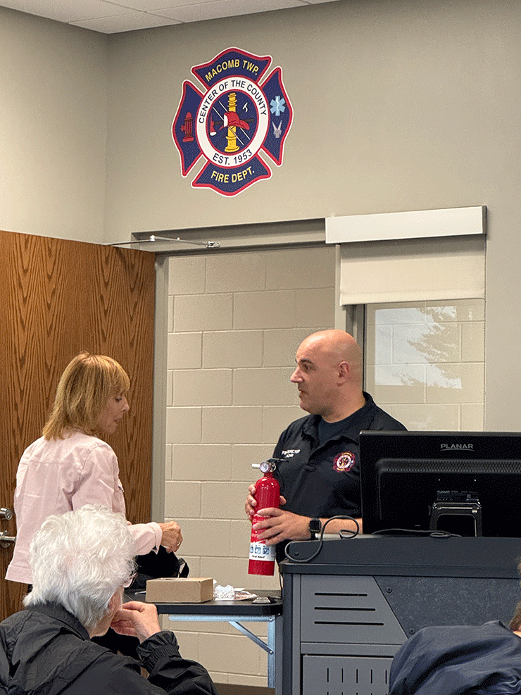 Inspector teaching senior citizen fire education